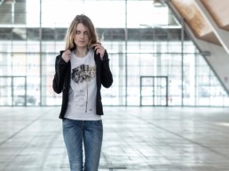 una donna passeggia indossando una t-shirt donna Paul Cortese sotto un giacchino nero